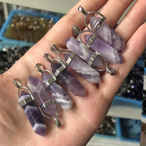 Detailed view of hexagonal natural purple amethyst pendants with silver metal clasps