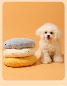 Close-up of soft fleece cat pillows with heart embroidery and cute dog model