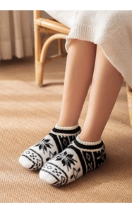 Detailed knit texture of Nordic snowflake patterns on cozy thick winter home socks