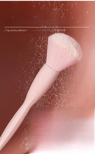 Macro shot of pink makeup brush with bionic fiber bristles showing powder absorption