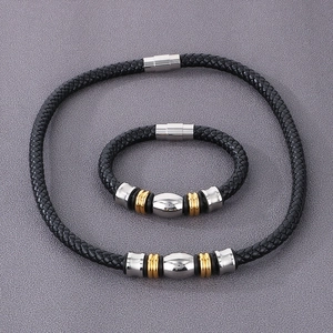 Détail de bracelet en cuir tressé avec perles bicolores et fermoir magnétique
