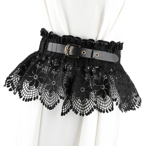 Detail of vintage black floral lace corset belt with a gold buckle on white fabric