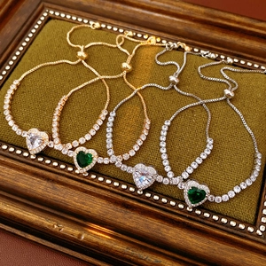 Detail view of heart-shaped zircon tennis bracelets with adjustable sliding clasps in gold and silver