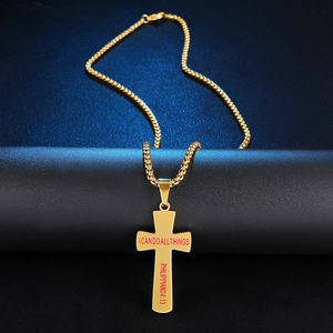Detailed shot of golden stainless steel cross pendant with Philippians 4:13 scripture
