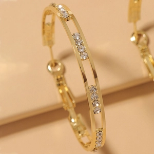 Elegant gold hoop earrings with sparkling white zircons and hollow geometric metal design