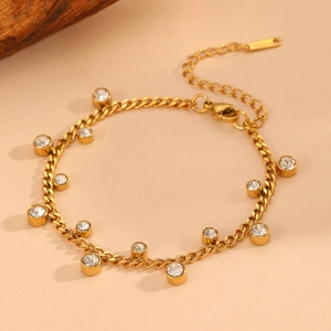 Detail of gold stainless steel bracelet featuring multiple round clear zircon pendants