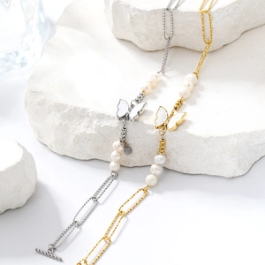 Detailed close-up of gold and silver butterfly pearl bracelets with OT toggle clasps