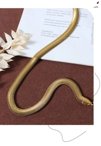 Close-up detail of a minimalist 18K gold plated herringbone snake chain for women