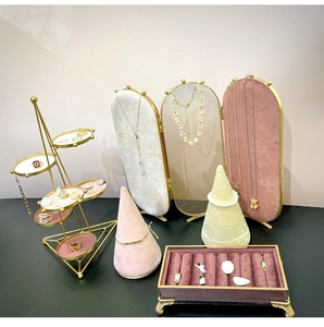 Detailed pink velvet jewelry display set with gold frame and earring screen organizer