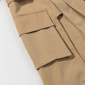 British style khaki trench coat featuring large flap pockets and premium fabric texture