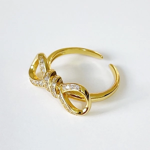 Gold bow-shaped 925 silver ring with zircon stones, adjustable open band style