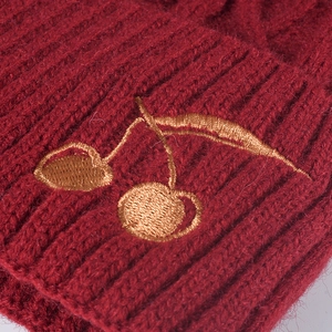 Winter red knitted beanie with thick fleece lining and golden cherry embroidery detail