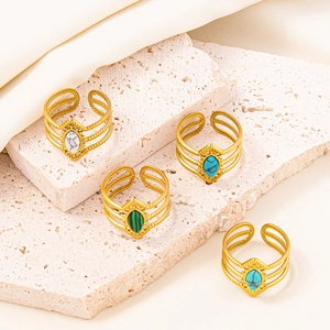 Adjustable 304 stainless steel rings with colorful gemstones on a stone background