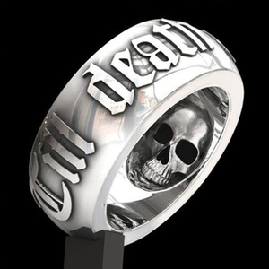 Close-up of gothic silver ring with embossed DEATH lettering and internal skull detail
