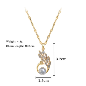 Detail showing dimensions of peacock necklace with pearl and rhinestones 3.2cm x 1.5cm