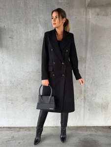 Close-up of double-breasted black wool coat with wide lapels and slim fit tailoring