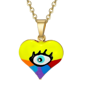 Detailed close-up of heart pendant featuring colorful enamel eyes on a gold chain