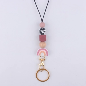 Detail of beaded lanyard featuring silicone beads, wood elements and a rainbow charm