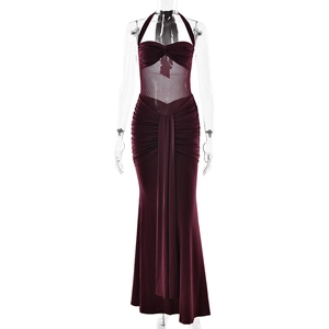 Detail of burgundy halter neck dress with sheer mesh panels and ruched fabric texture