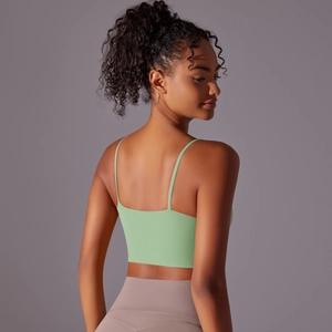 Rear view of mint green yoga vest with slim straps showing back fit on model