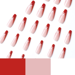 Christmas red French press-on nails with white snowflake patterns in a diagonal array layout