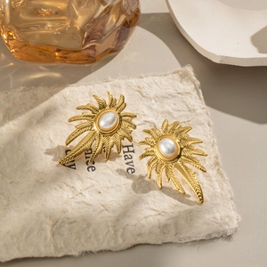 Elegant gold palm leaf earrings with oval pearl accent in a vintage minimalist design