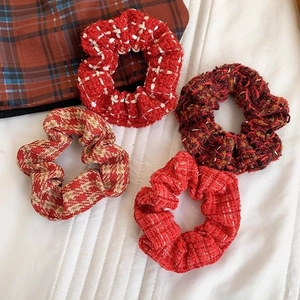 Set of 4 elegant knitted scrunchies in red and plaid patterns on white fabric