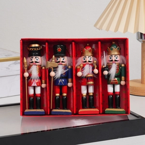 Detail of four 13cm glitter wooden nutcracker soldiers in a red festive gift box