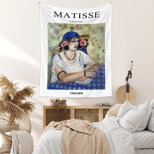 Detail of bohemian tapestry featuring Henri Matisse art print in a cozy bedroom setting