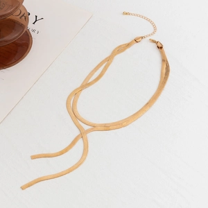 Detail of golden double-layer snake bone chain necklace with lobster clasp and extender