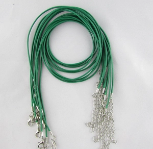 Close-up of green waxed cord necklace strings with silver lobster clasps and extension chains