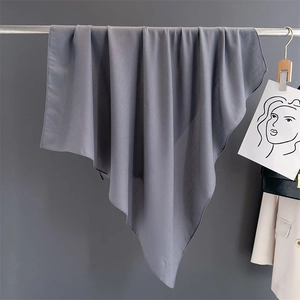Detail view of a gray cotton linen scarf draped elegantly over a metallic rod