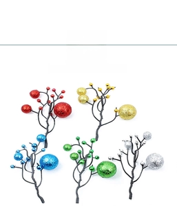 Detail of colorful glitter Christmas berry picks in red, gold, blue, green, and silver