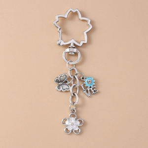 Detailed silver keychain with sakura ring, butterfly, blue flower, and LOVE charms