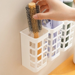 Wall-mounted white mesh storage basket for hair styling tools and vanity accessories