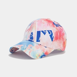 Detail of vibrant tie-dye baseball cap with artistic blue graffiti lettering print