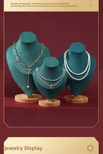 Three-piece dark green velvet necklace display stands with wooden bases in tiered sizes