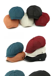 Close-up of summer mesh beret hats showing breathable textured fabric and metal detail