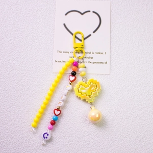 Detail of yellow pixel heart charm with beaded chain and I LOVE U alphabet beads