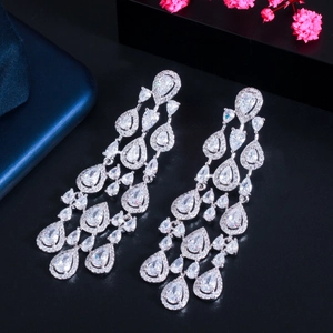 Close-up of elegant silver tassel earrings with pear-shaped cubic zirconia crystals