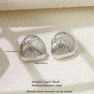Detailed view of silver stainless steel triangle earrings with vertical stripe texture