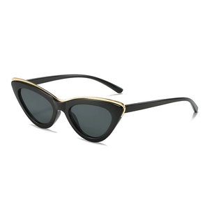 Fashion cat eye sunglasses with black frames and golden metal trim in 3/4 side view