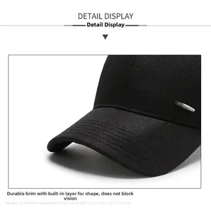 Detailed close-up of a black mesh baseball cap with a silver rectangular metal logo plate