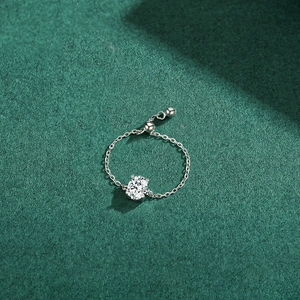 Adjustable S925 silver chain ring with oval sparkling cubic zirconia on green background