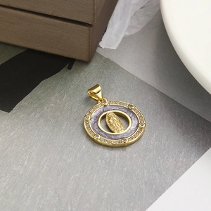 Detail of a round Virgin Mary pendant with purple enamel and zircon inlay on textured paper