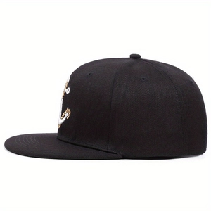Black snapback hat with gold anchor embroidery viewed from a forty-five degree angle