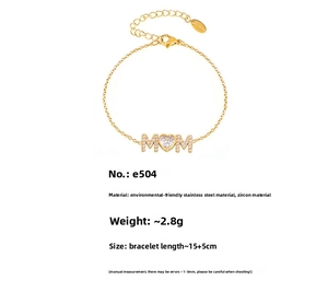 Detailed close-up of gold MOM bracelet with heart-shaped zircon and lobster clasp