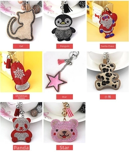 Detail showing various crystal rhinestone animal keychains with tassels and bells
