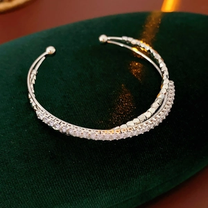 Macro detail of silver double-layered open bracelet with micro-pave cubic zirconia