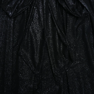 Close-up of black sequined fabric showing detailed texture and mesh stitching detail